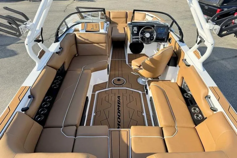 Slide: The Image of 2027 Moomba Max boat interior with tan seating and modern dashboard. - 5