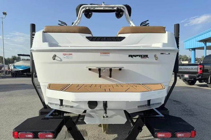 Slide: The Image of 2027 Moomba Max boat rear view with Raptor engine, parked on trailer. - 9