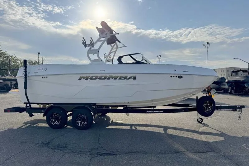 The Image of 2027 Moomba Max boat on trailer under sunny sky. - 0