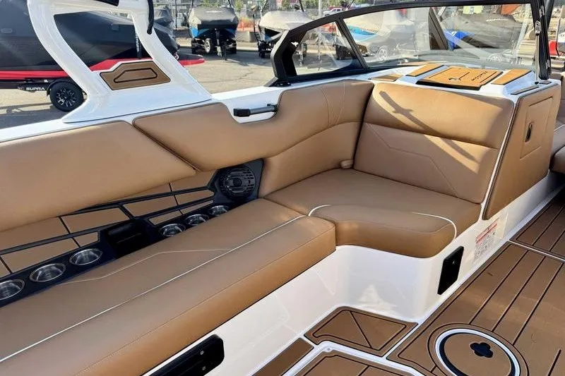 Slide: The Image of 2027 Moomba Max boat interior with tan seating and modern design. - 6