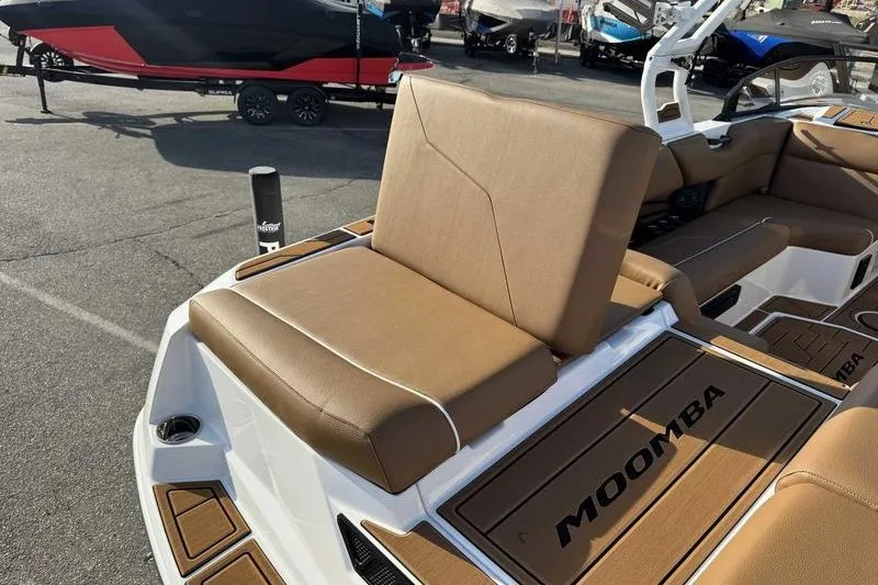 Slide: The Image of 2027 Moomba Max boat interior with tan seating and branded flooring. - 1