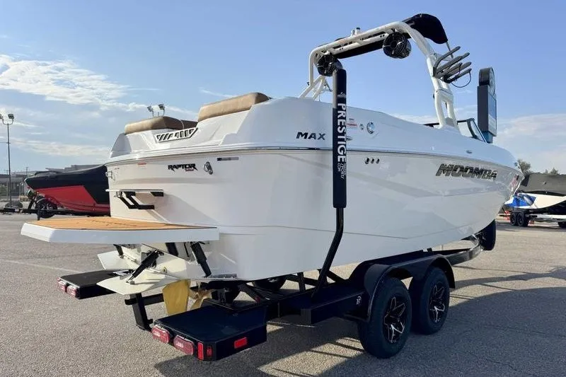 Slide: The Image of 2027 Moomba Max boat on trailer, rear view, parked outdoors. - 4