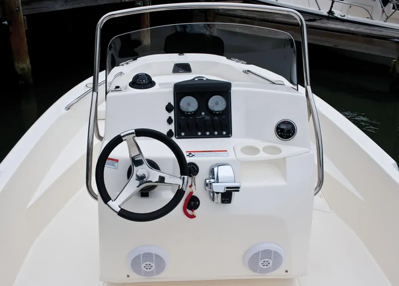 Slide: The Image of Manufacturer Provided Image: 2014 Boston Whaler 180 Dauntless boat console with steering wheel and controls. - 11