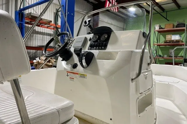 Slide: The Image of 2014 Boston Whaler 180 Dauntless boat interior with steering console and seating. - 3