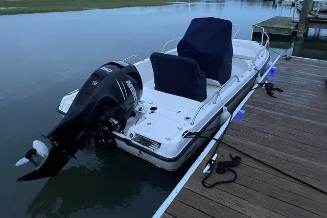 Slide: The Image of 2014 Boston Whaler 180 Dauntless boat docked with Mercury outboard motor. - 2
