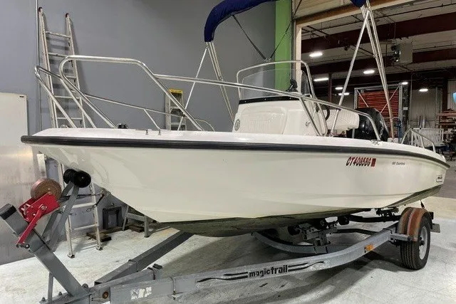 Slide: The Image of 2014 Boston Whaler 180 Dauntless boat on trailer in indoor storage facility. - 0