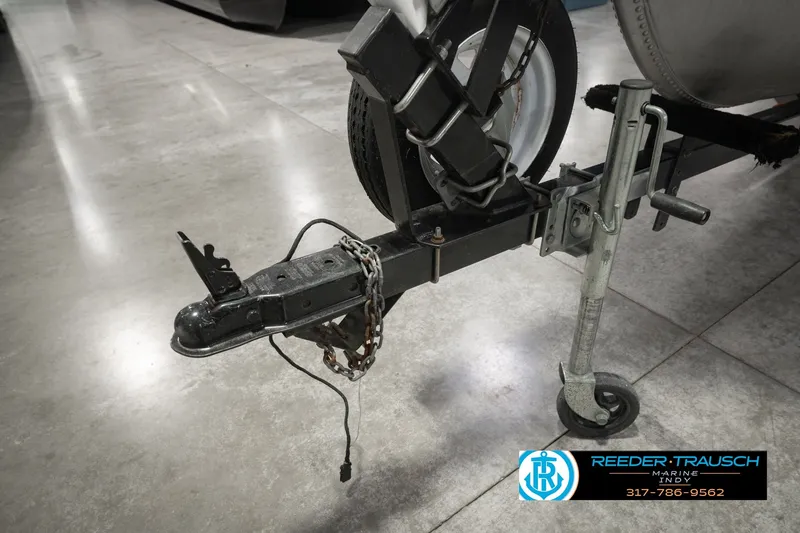 Slide: The Image of Trailer hitch of a 2004 Smoker Craft Voyager boat, displayed indoors. - 43