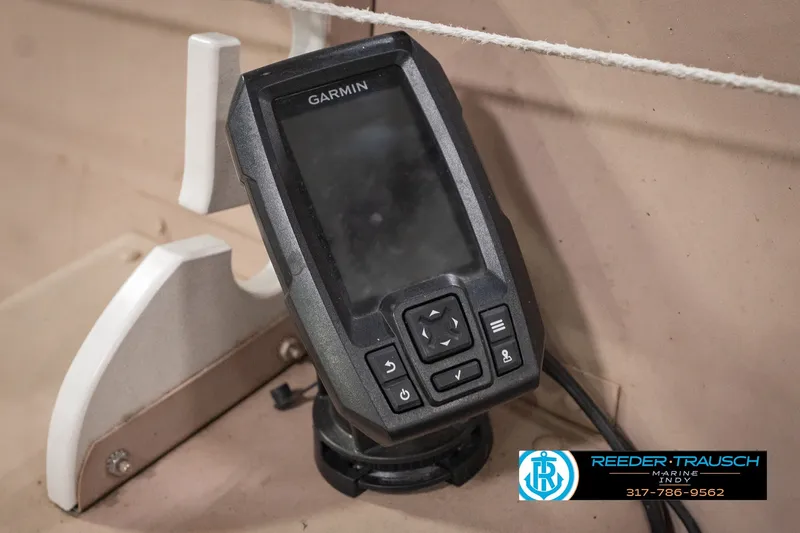 Slide: The Image of Garmin device mounted on 2004 Smoker Craft Voyager boat dashboard. - 31