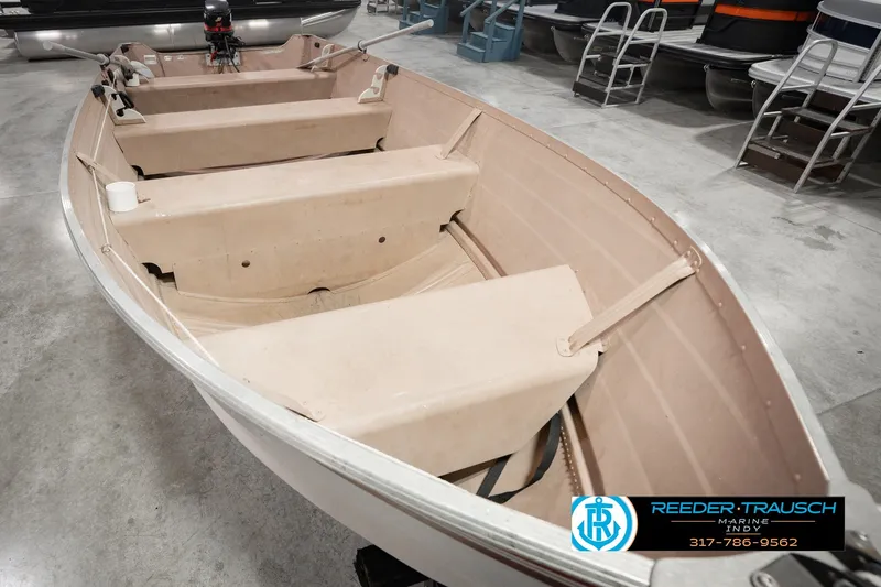Slide: The Image of 2004 Smoker Craft Voyager boat with oars, displayed indoors at Reeder Trausch Marine. - 13