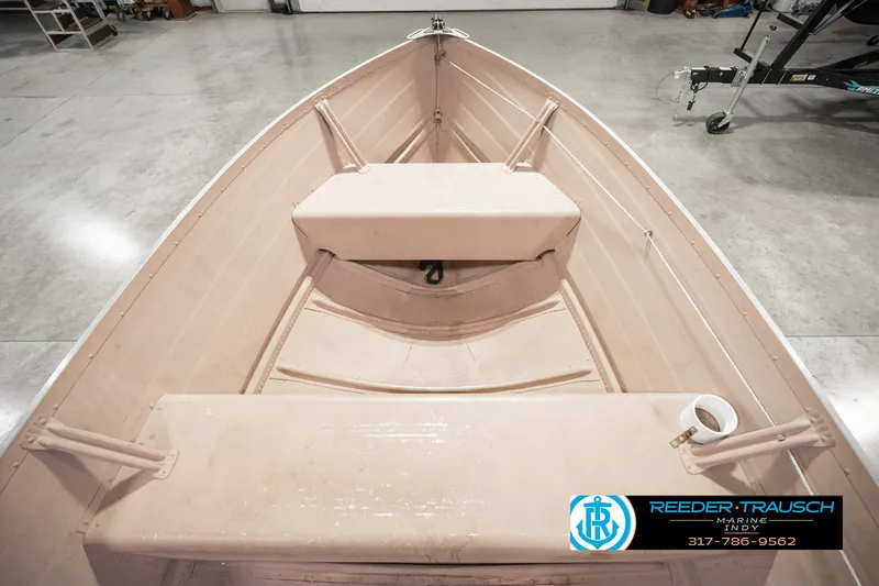 Slide: The Image of 2004 Smoker Craft Voyager boat interior with seating, displayed in a showroom. - 20