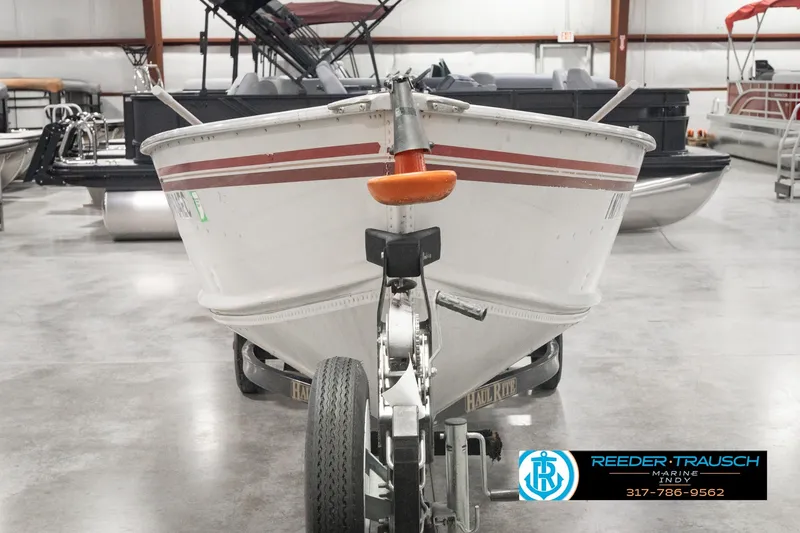 Slide: The Image of 2004 Smoker Craft Voyager boat on trailer in indoor showroom. - 2
