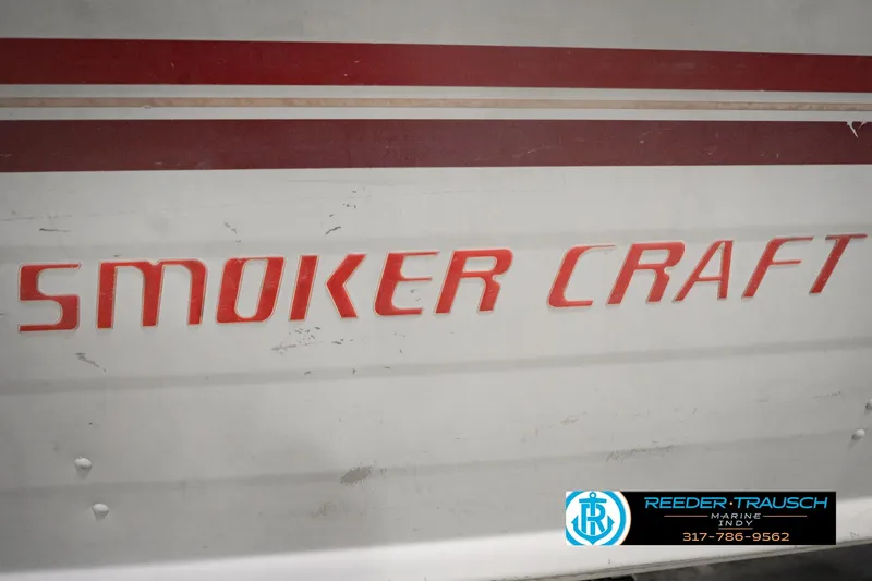 Slide: The Image of 2004 Smoker Craft Voyager boat with red lettering and Reeder Trausch Marine logo. - 41