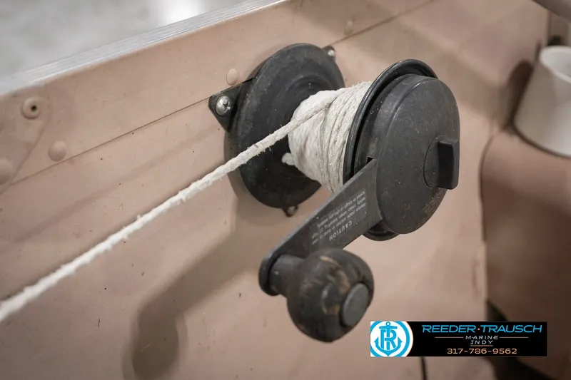Slide: The Image of Close-up of a 2004 Smoker Craft Voyager boat winch with rope. - 34