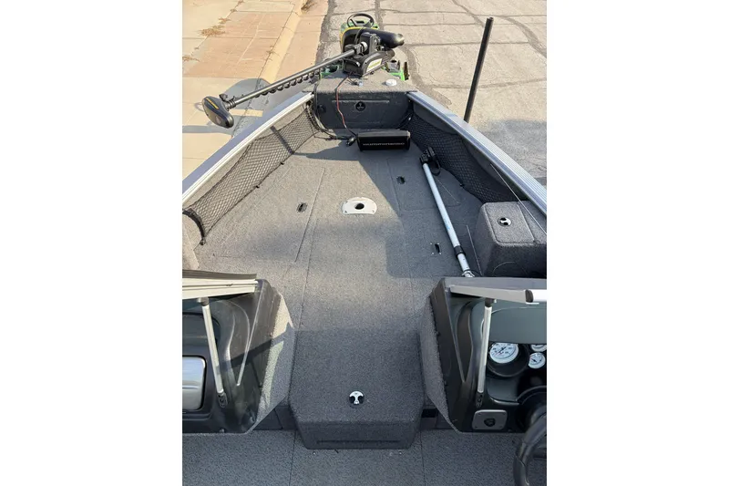 Slide: The Image of 2019 Lund 2025 Impact XS boat interior with fishing gear and storage compartments. - 7