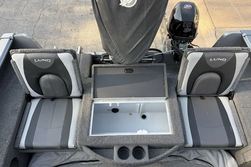 Slide: The Image of 2019 Lund 2025 Impact XS boat interior with seating and storage compartments. - 5