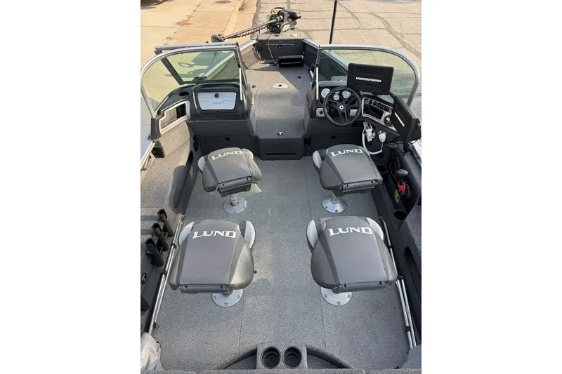 Slide: The Image of 2019 Lund 2025 Impact XS boat interior with four seats and steering console. - 6
