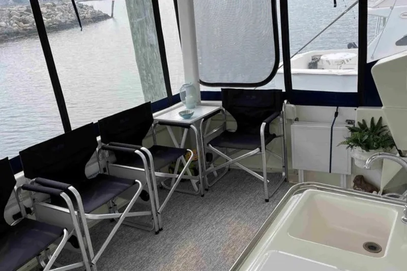 Slide: The Image of Interior of a 1997 Silverton 372 Motor Yacht with seating and a table. - 21
