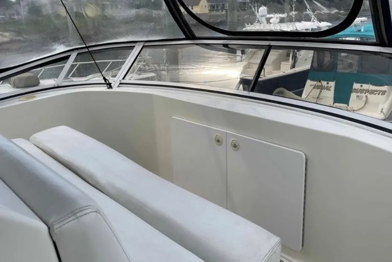 Slide: The Image of The image shows the cockpit of a 1997 Silverton 372 Motor Yacht with white seating. - 18