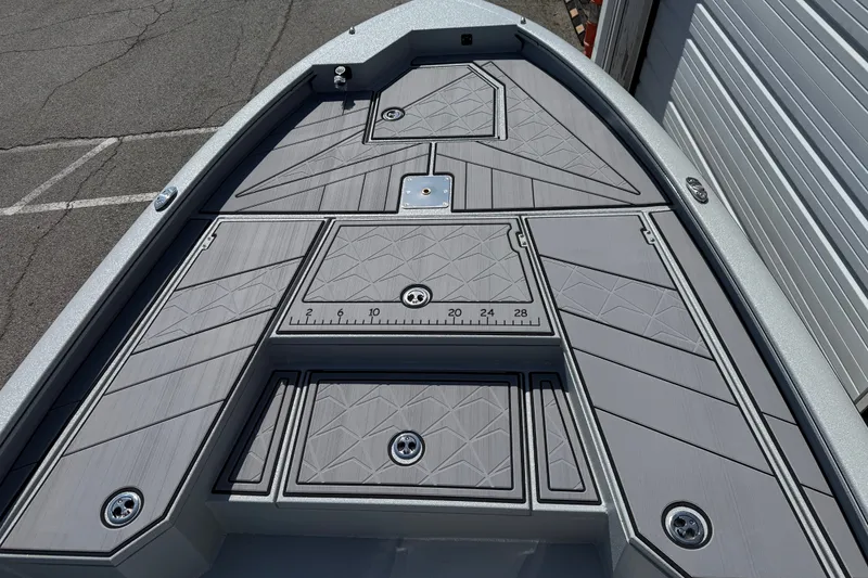 Slide: The Image of Bow deck of 2027 Avid 23 Mag boat with textured surface and measurement markings. - 8
