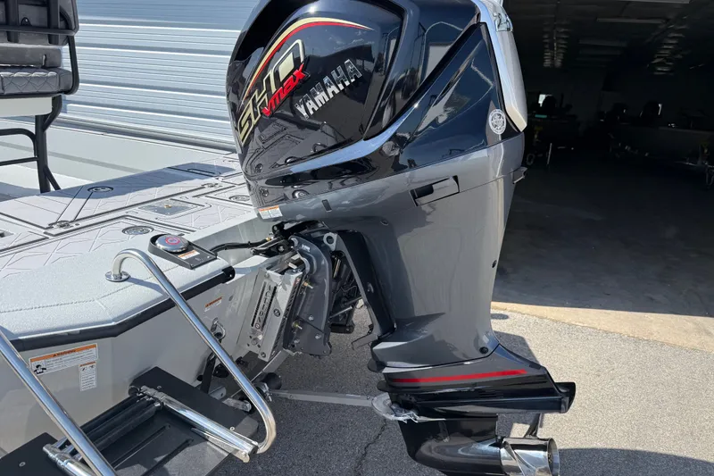 Slide: The Image of Avid 23 Mag 2027 boat with Yamaha VMAX outboard motor in a garage setting. - 4