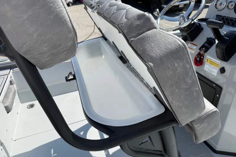 Slide: The Image of 2027 Avid 23 Mag boat interior with gray seating and storage compartment. - 21