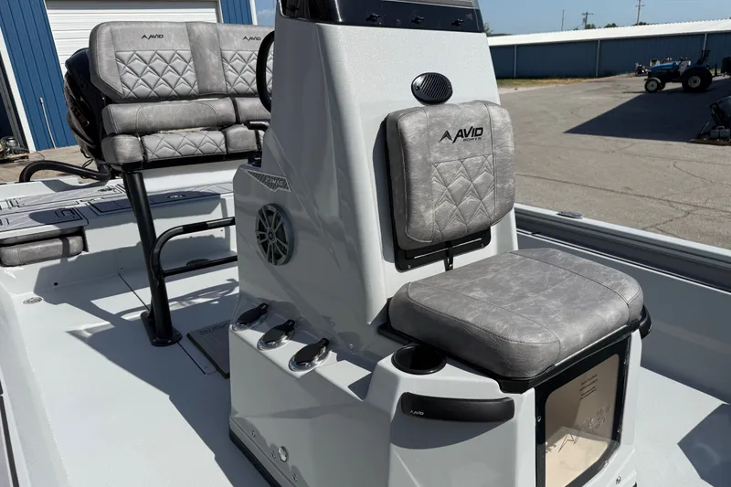 Slide: The Image of 2027 Avid 23 Mag boat interior with gray cushioned seating and modern design. - 12