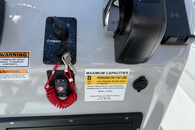 Slide: The Image of Control panel of 2027 Avid 23 Mag boat with Yamaha ignition and capacity warning. - 19