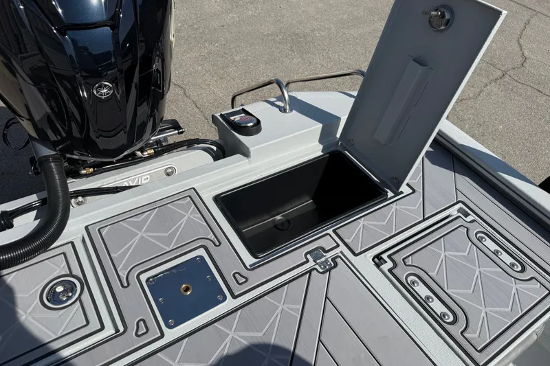Slide: The Image of Avid 23 Mag 2027 boat deck with open storage compartment and motor. - 26