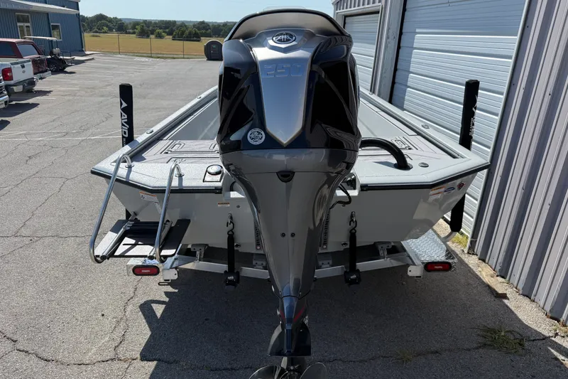 Slide: The Image of Avid 23 Mag 2027 boat with powerful outboard motor in a parking area. - 3