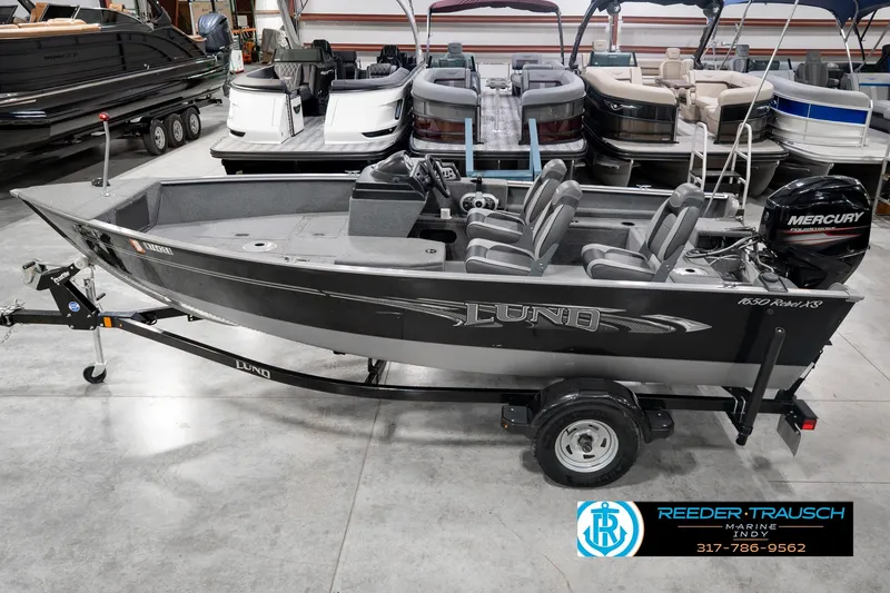 The Image of 2017 Lund 1650 Rebel XS SS fishing boat in showroom, featuring Mercury outboard engine. - 0