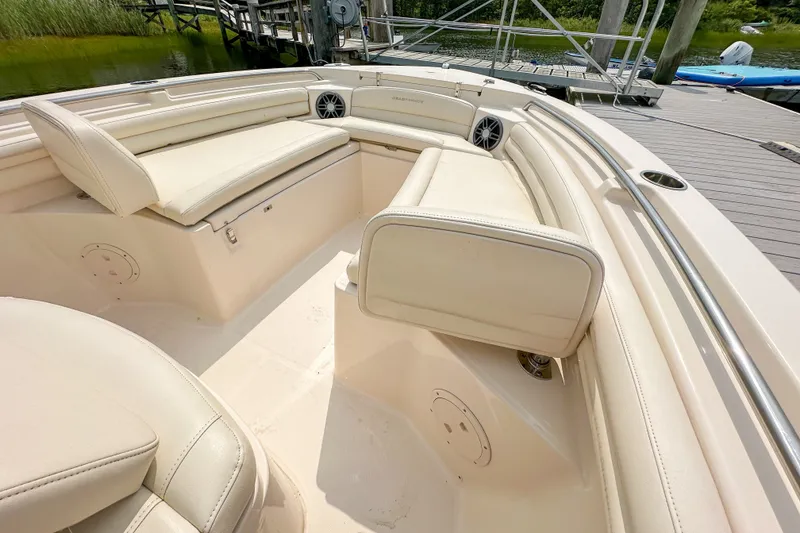 Slide: The Image of 2022 Grady-White Fisherman 216 boat interior with cushioned seating and speakers. - 28