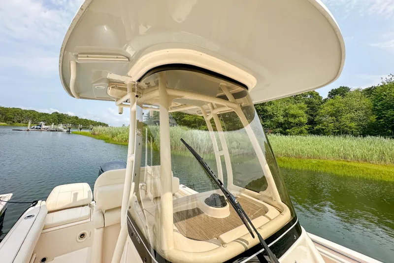 Slide: The Image of 2022 Grady-White Fisherman 216 boat on a serene lake with lush greenery. - 33