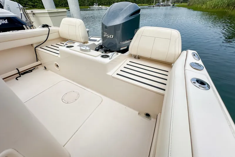 Slide: The Image of 2022 Grady-White Fisherman 216 boat interior with Yamaha 250 engine, docked by water. - 21