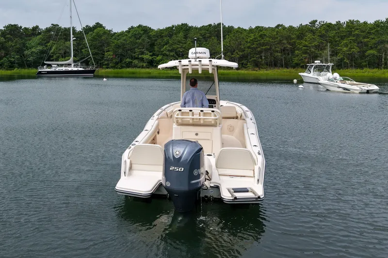 Slide: The Image of 2022 Grady-White Fisherman 216 boat on calm water, surrounded by lush greenery. - 37