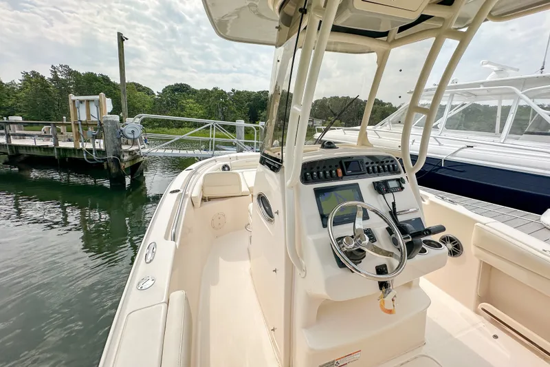 Slide: The Image of 2022 Grady-White Fisherman 216 boat at dock, featuring modern helm controls. - 13