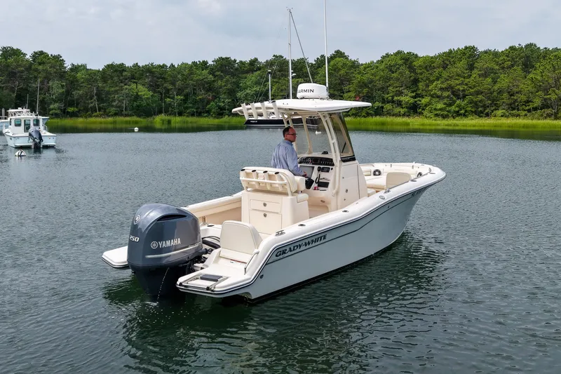 Slide: The Image of 2022 Grady-White Fisherman 216 boat on calm water, featuring Yamaha engine. - 38