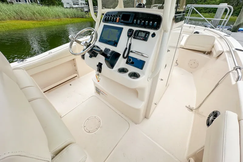 Slide: The Image of 2022 Grady-White Fisherman 216 boat interior with steering console and navigation equipment. - 11