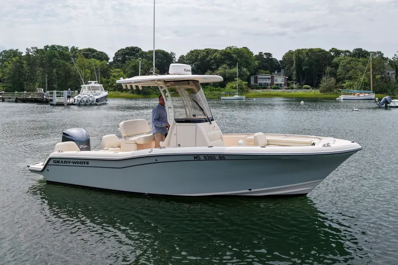 The Image of 2022 Grady-White Fisherman 216 boat on calm water, surrounded by lush greenery. - 0