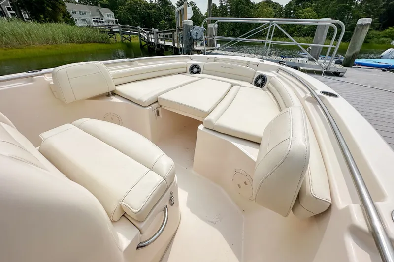 Slide: The Image of 2022 Grady-White Fisherman 216 boat interior with cushioned seating and dock view. - 26
