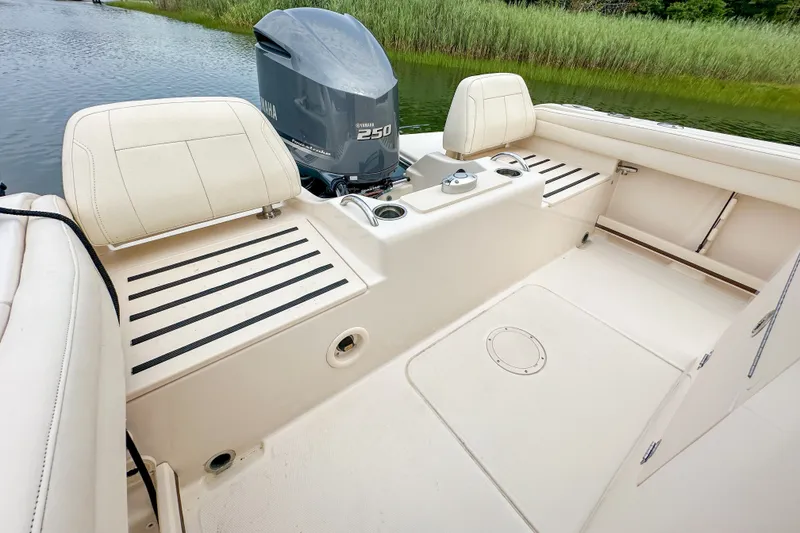 Slide: The Image of 2022 Grady-White Fisherman 216 boat interior with Yamaha 250 engine, near water and reeds. - 22