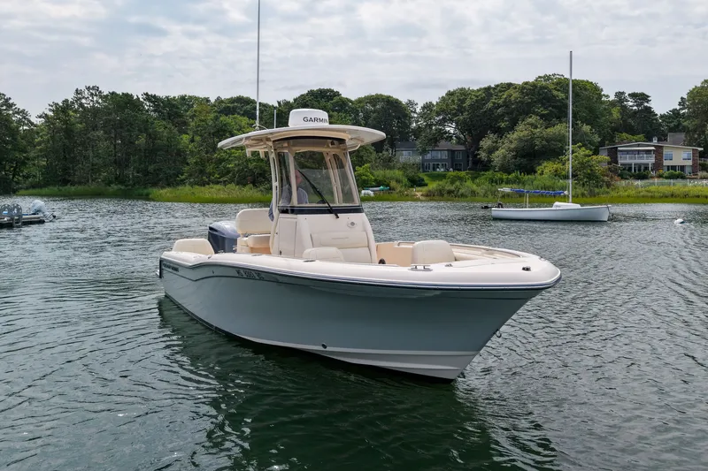 Slide: The Image of 2022 Grady-White Fisherman 216 boat on a serene lake with lush greenery. - 45