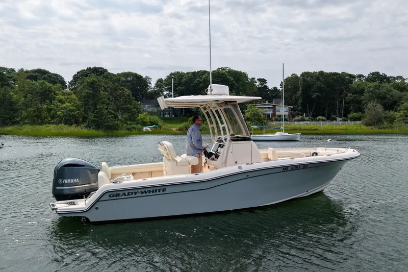 Slide: The Image of 2022 Grady-White Fisherman 216 boat on water with Yamaha engine, surrounded by greenery. - 43