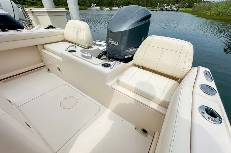 Slide: The Image of 2022 Grady-White Fisherman 216 boat interior with Yamaha 250 engine, docked on calm water. - 25