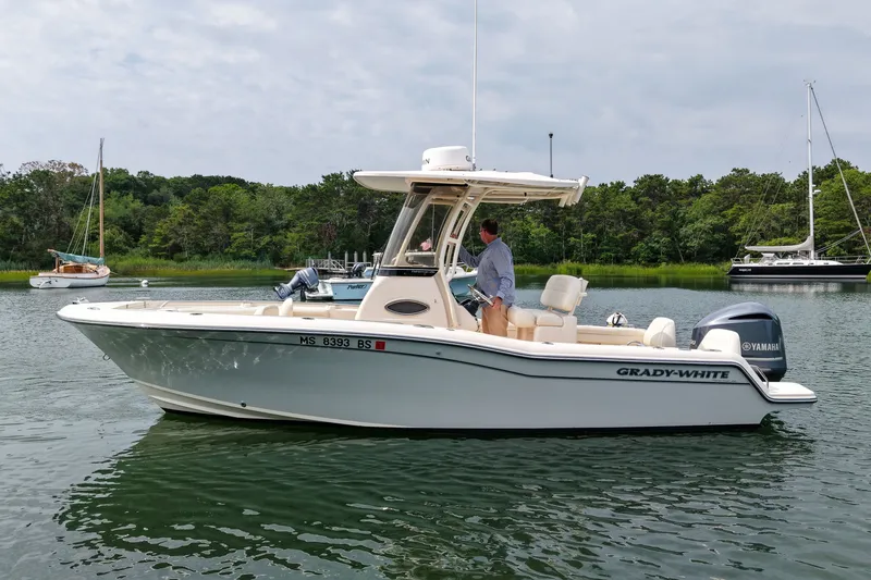 Slide: The Image of 2022 Grady-White Fisherman 216 boat on calm water with lush green background. - 41
