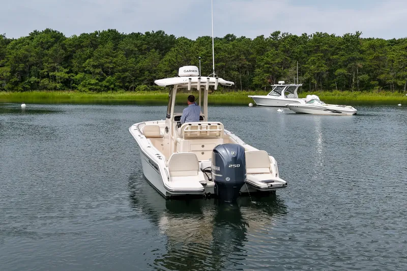 Slide: The Image of 2022 Grady-White Fisherman 216 boat on calm water, surrounded by lush greenery. - 36