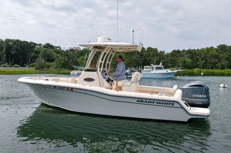 Slide: The Image of 2022 Grady-White Fisherman 216 boat on calm water with Yamaha engine. - 40