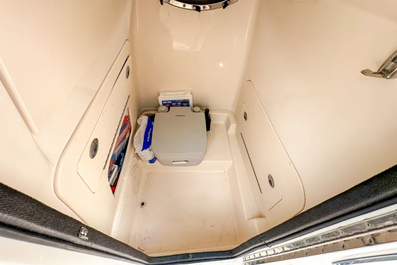 Slide: The Image of 2022 Grady-White Fisherman 216 boat interior storage compartment with portable toilet. - 34