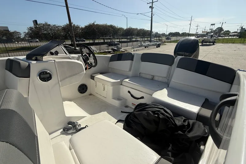 Slide: The Image of 2025 Tahoe T16 boat interior with seating, steering wheel, and storage compartments. - 19