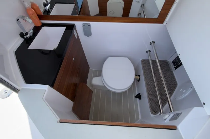 Slide: The Image of 2023 Axopar 28 Cabin bathroom with modern fixtures and compact design. - 35
