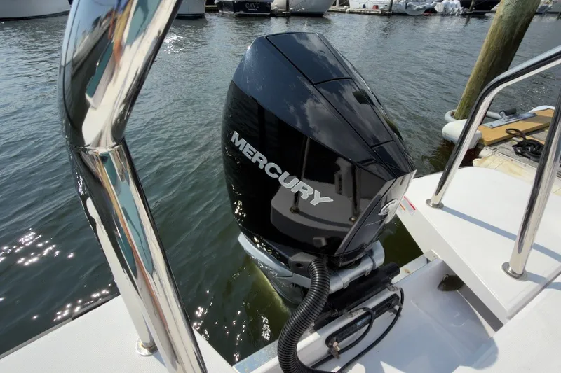 Slide: The Image of Mercury outboard motor on 2023 Axopar 28 Cabin boat, docked at marina. - 46